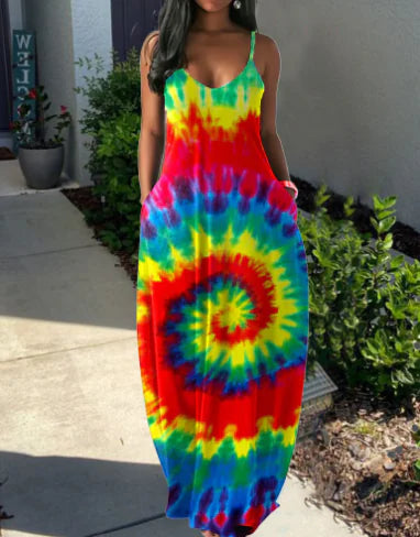 Person wearing a colorful tie-dye dress standing outdoors. From ghg wellness shop.