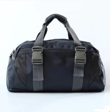 Black duffel bag with gray straps on a white background, from ghg global powerhouse.