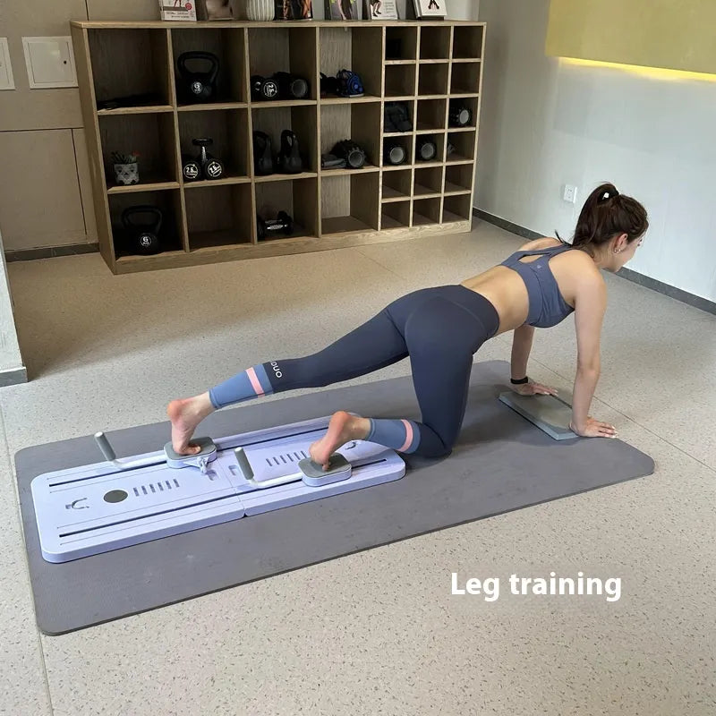 Woman performing leg training on a mat with exercise equipment in the background, from ghg global powerhouse.
